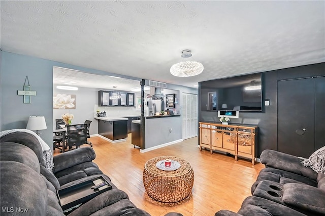 245 N Rd, Niles, OH 44446 - living room featuring light wood-style floors, baseboards, and a textured ceiling