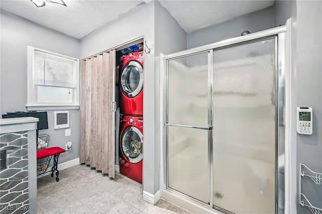 245 N Rd, Niles, OH 44446 - laundry area featuring stacked washer / dryer, baseboards, and a textured ceiling