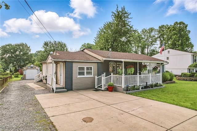 245 N Rd, Niles, OH 44446 - view of front of property featuring a porch, a front yard, an outbuilding, driveway, and a shingled roof