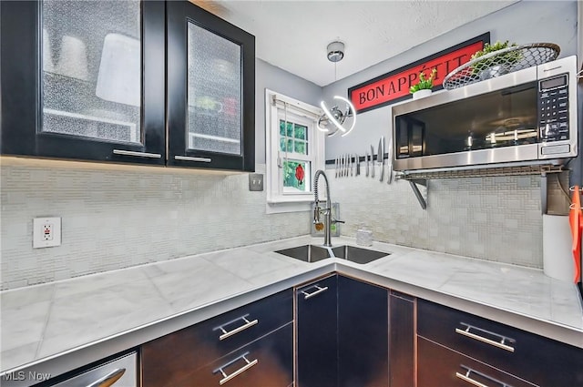 245 N Rd, Niles, OH 44446 - kitchen with stainless steel microwave, a sink, backsplash, and glass insert cabinets