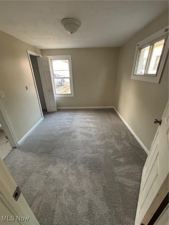 4721 Ardmore Ave, Cleveland, OH 44144 - unfurnished bedroom featuring baseboards, multiple windows, and carpet