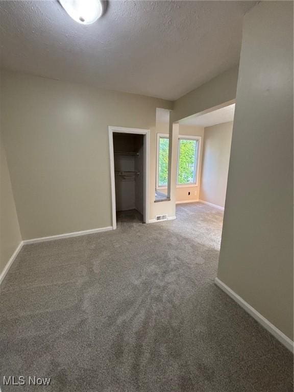 4721 Ardmore Ave, Cleveland, OH 44144 - carpeted empty room featuring baseboards and a textured ceiling