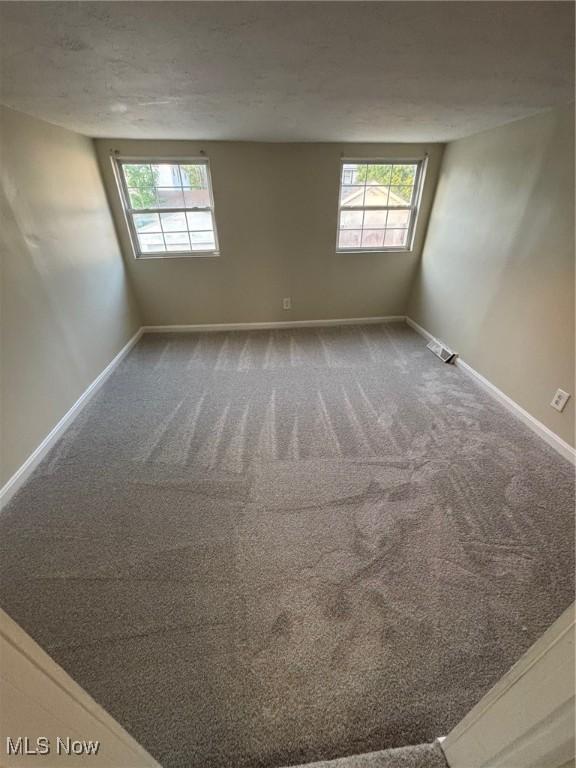 4721 Ardmore Ave, Cleveland, OH 44144 - unfurnished room featuring plenty of natural light, baseboards, and carpet