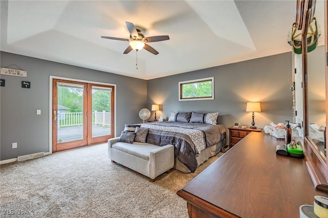 8921 Auburn Rd, Chardon, OH 44024 - carpeted bedroom with access to outside, multiple windows, a tray ceiling, and a ceiling fan