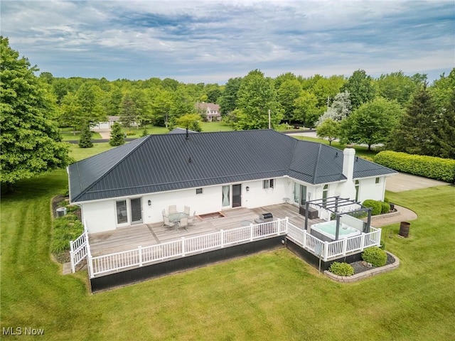 8921 Auburn Rd, Chardon, OH 44024 - back of house with a deck, metal roof, a lawn, and stucco siding