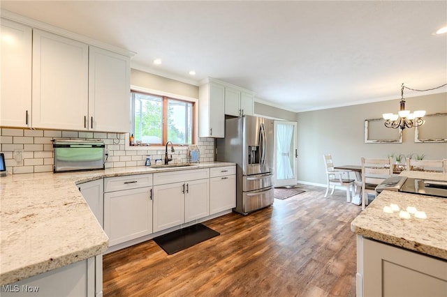 8921 Auburn Rd, Chardon, OH 44024 - kitchen with stainless steel fridge, a sink, crown molding, tasteful backsplash, and a chandelier