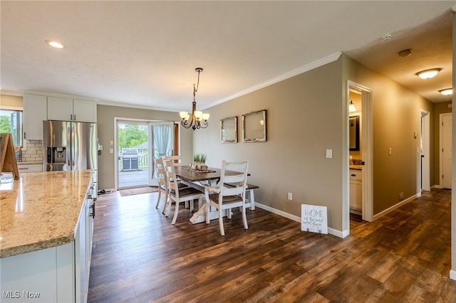8921 Auburn Rd, Chardon, OH 44024 - dining area featuring healthy amount of natural light, crown molding, dark wood finished floors, a chandelier, and baseboards