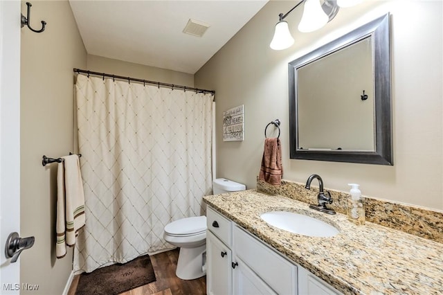 8921 Auburn Rd, Chardon, OH 44024 - bathroom with toilet, vanity, wood finished floors, and curtained shower