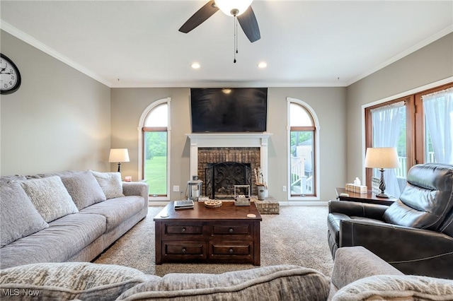 8921 Auburn Rd, Chardon, OH 44024 - carpeted living room with ornamental molding, a ceiling fan, healthy amount of natural light, a fireplace, and recessed lighting