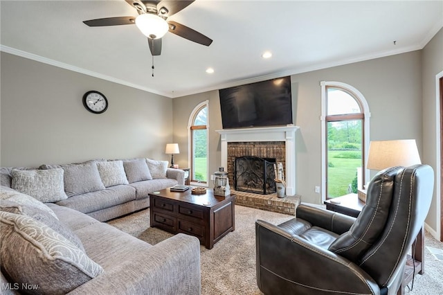 8921 Auburn Rd, Chardon, OH 44024 - living room featuring light carpet, a fireplace, plenty of natural light, crown molding, and ceiling fan