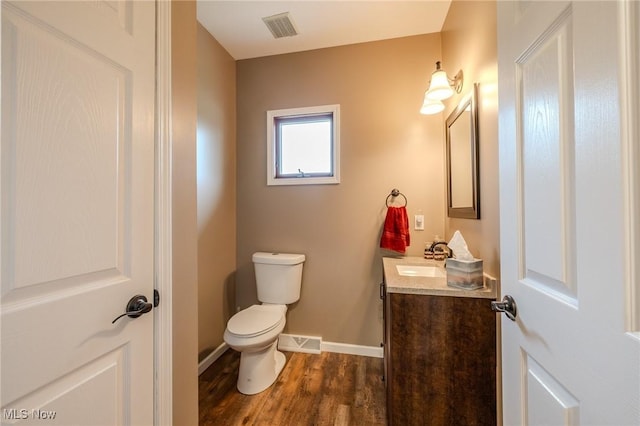 8921 Auburn Rd, Chardon, OH 44024 - bathroom featuring vanity, toilet, wood finished floors, and baseboards