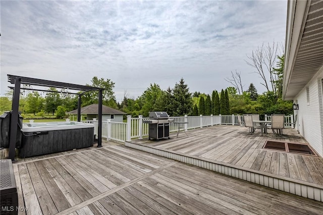 8921 Auburn Rd, Chardon, OH 44024 - wooden deck with a hot tub, outdoor dining area, grilling area, and view of wooded area