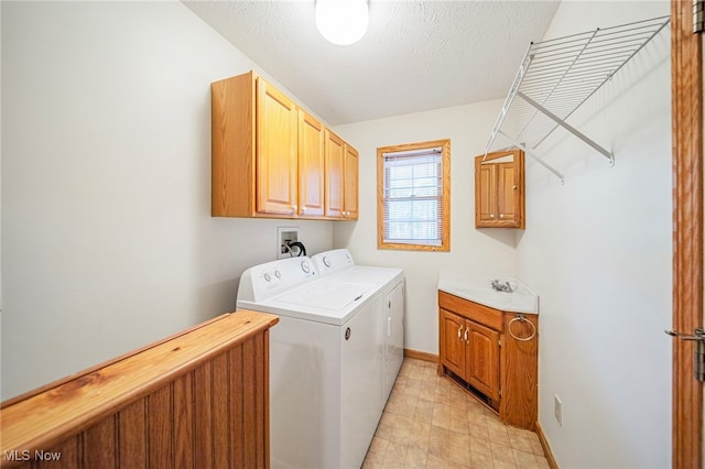 7410 Fieldstone Ave, Conneaut, OH 44030 - washroom featuring cabinet space, washing machine and dryer, baseboards, and a textured ceiling