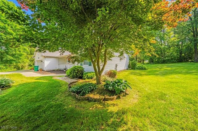 7410 Fieldstone Ave, Conneaut, OH 44030 - view of front of house featuring a front yard, a garage, and concrete driveway
