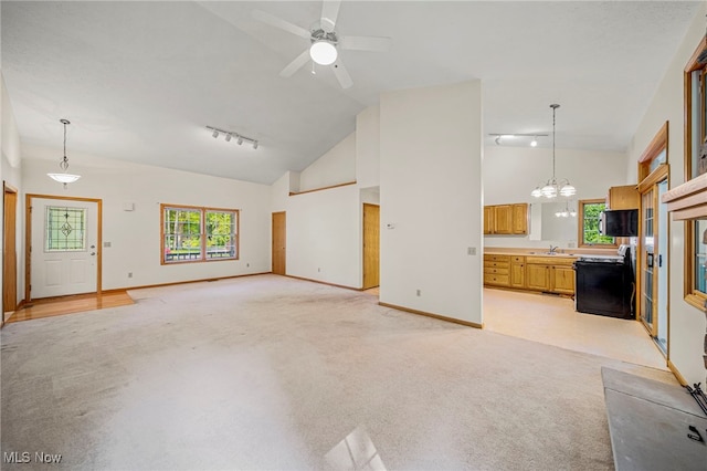 7410 Fieldstone Ave, Conneaut, OH 44030 - unfurnished living room with light carpet, a chandelier, a sink, baseboards, and rail lighting