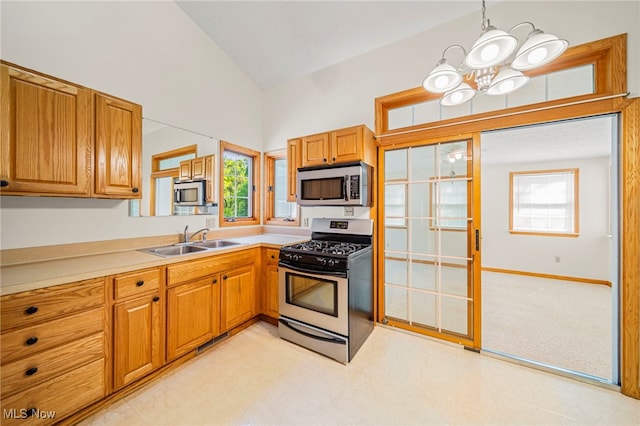 7410 Fieldstone Ave, Conneaut, OH 44030 - kitchen with appliances with stainless steel finishes, a sink, a chandelier, light countertops, and high vaulted ceiling