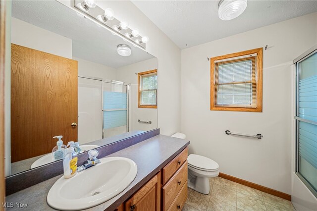 7410 Fieldstone Ave, Conneaut, OH 44030 - bathroom featuring a shower with door, vanity, baseboards, and toilet