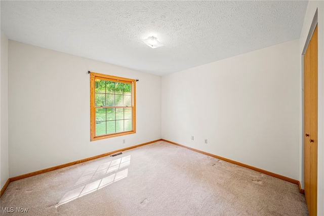 7410 Fieldstone Ave, Conneaut, OH 44030 - carpeted spare room with baseboards and a textured ceiling