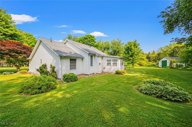 7410 Fieldstone Ave, Conneaut, OH 44030 - back of house with a yard and roof with shingles