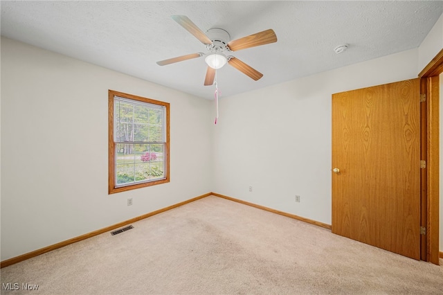 7410 Fieldstone Ave, Conneaut, OH 44030 - empty room featuring carpet floors, baseboards, a ceiling fan, a smoke detector, and a textured ceiling