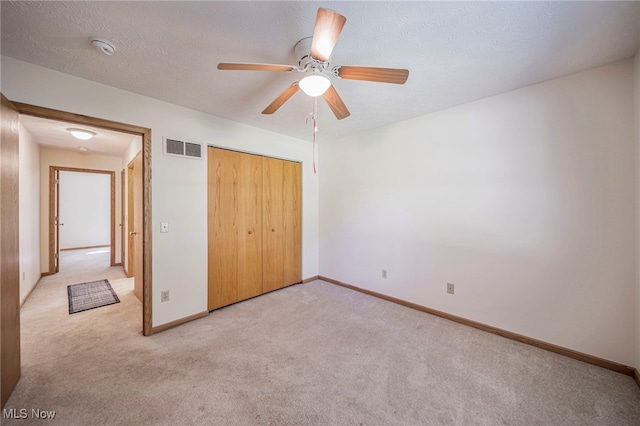 7410 Fieldstone Ave, Conneaut, OH 44030 - unfurnished bedroom with light carpet, baseboards, a closet, ceiling fan, and a textured ceiling