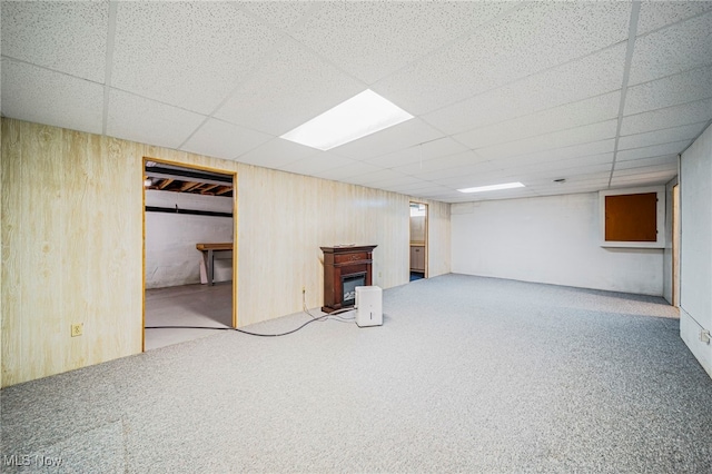 7410 Fieldstone Ave, Conneaut, OH 44030 - finished below grade area with a glass covered fireplace, carpet flooring, a drop ceiling, and wooden walls