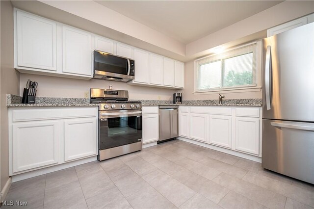 3406 Rebecca Dr, Canfield, OH 44406 - kitchen with appliances with stainless steel finishes, white cabinetry, and light stone countertops