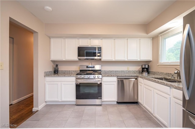 3406 Rebecca Dr, Canfield, OH 44406 - kitchen with stainless steel appliances, white cabinetry, and a sink
