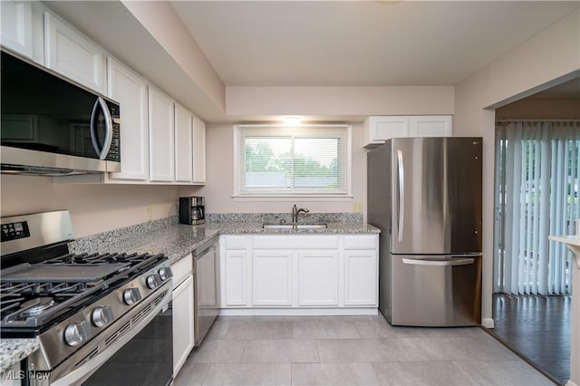 3406 Rebecca Dr, Canfield, OH 44406 - kitchen with stainless steel appliances, a sink, white cabinetry, and light stone countertops