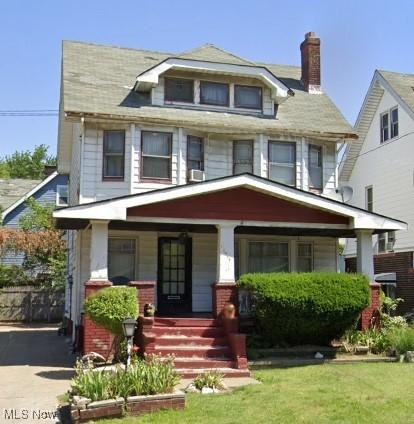 12517 Arlington Ave, Cleveland, OH 44108 - american foursquare style home featuring a porch, a chimney, and a front yard