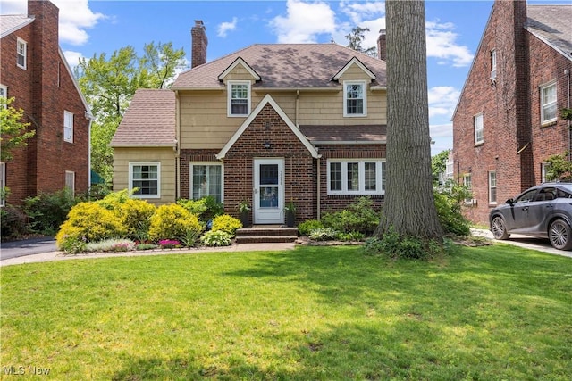 3280 Glencairn Rd, Shaker Heights, OH 44122 - view of front facade with a front yard, brick siding, a chimney, and a shingled roof