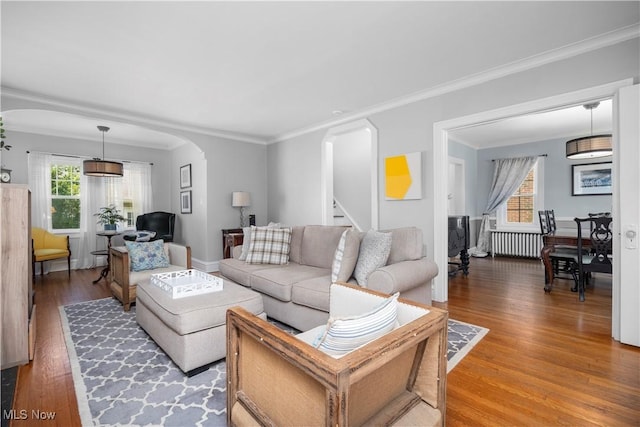 3280 Glencairn Rd, Shaker Heights, OH 44122 - living room with arched walkways, radiator heating unit, plenty of natural light, and ornamental molding