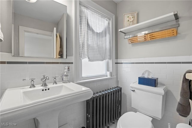 3280 Glencairn Rd, Shaker Heights, OH 44122 - bathroom featuring radiator heating unit, tile walls, toilet, a sink, and a wainscoted wall