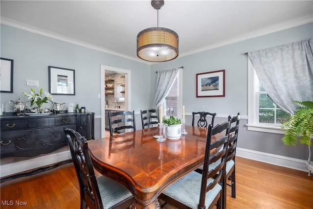 3280 Glencairn Rd, Shaker Heights, OH 44122 - dining space with light wood finished floors, crown molding, and baseboards