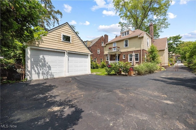 3280 Glencairn Rd, Shaker Heights, OH 44122 - view of front of home with an outbuilding, brick siding, a garage, and a chimney
