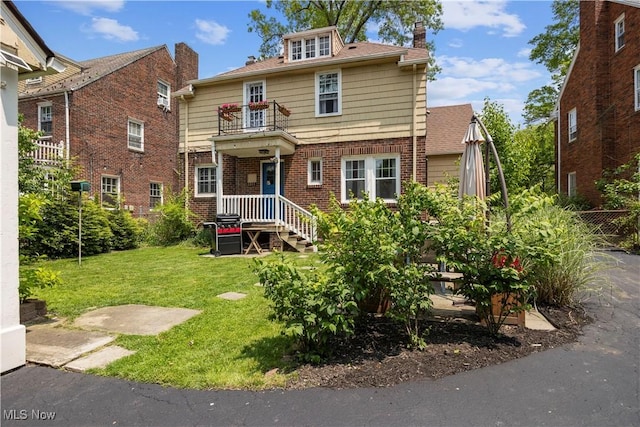 3280 Glencairn Rd, Shaker Heights, OH 44122 - view of front of home with a balcony, a front lawn, brick siding, and a chimney