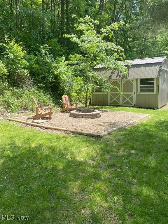4244 Hensel Dr SW, Carrollton, OH 44615 - view of green lawn featuring an outdoor fire pit and a view of trees