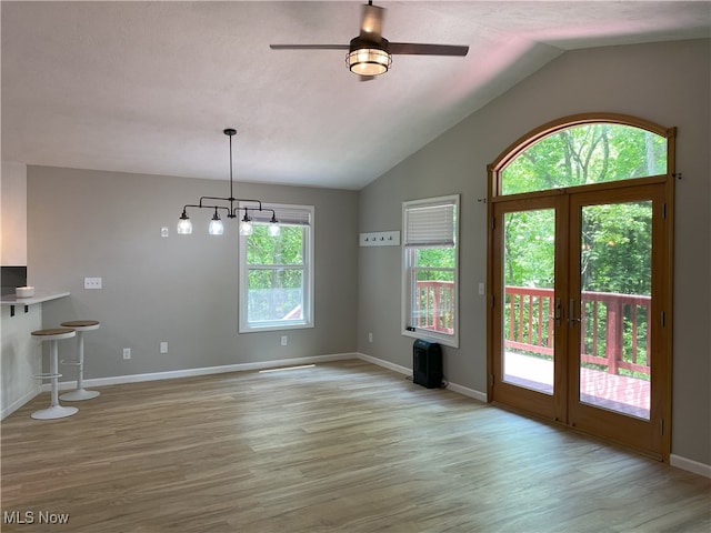 4244 Hensel Dr SW, Carrollton, OH 44615 - unfurnished living room with french doors, vaulted ceiling, wood finished floors, a ceiling fan, and baseboards