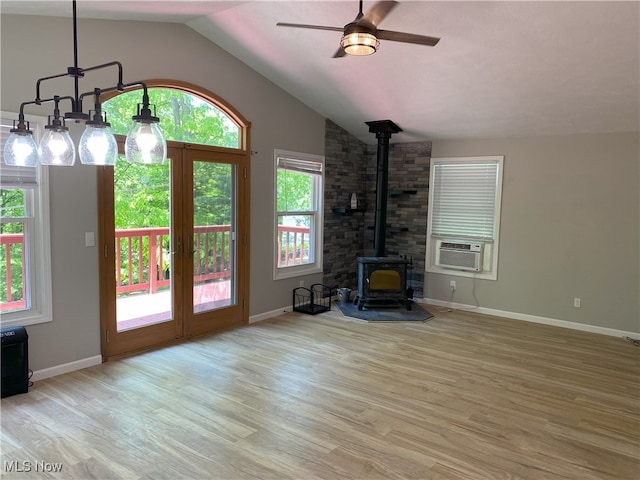 4244 Hensel Dr SW, Carrollton, OH 44615 - unfurnished living room featuring a wood stove, wood finished floors, lofted ceiling, ceiling fan, and cooling unit