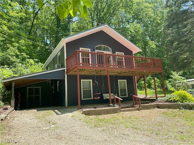 4244 Hensel Dr SW, Carrollton, OH 44615 - rear view of house with gravel driveway, a wooden deck, and an attached carport