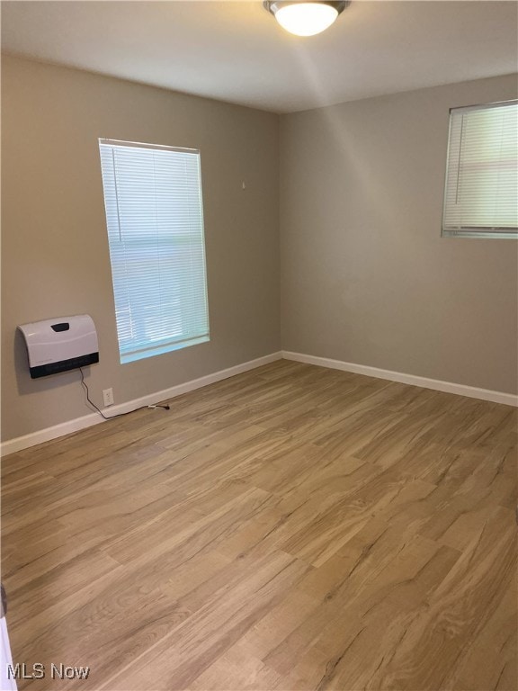 4244 Hensel Dr SW, Carrollton, OH 44615 - spare room with wood finished floors, baseboards, and heating unit