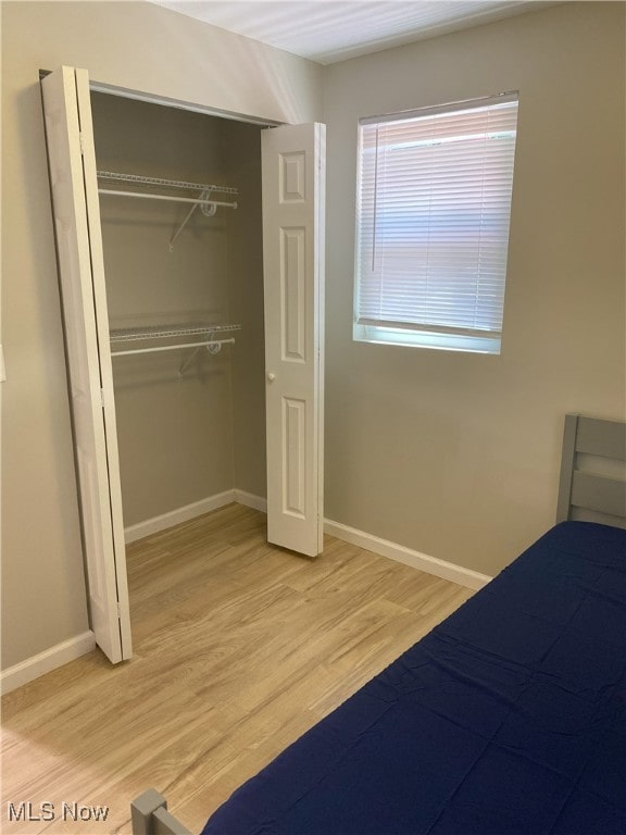 4244 Hensel Dr SW, Carrollton, OH 44615 - unfurnished bedroom featuring light wood-style flooring, a closet, and baseboards