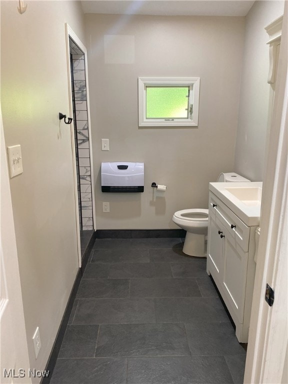 4244 Hensel Dr SW, Carrollton, OH 44615 - bathroom with vanity, toilet, and baseboards