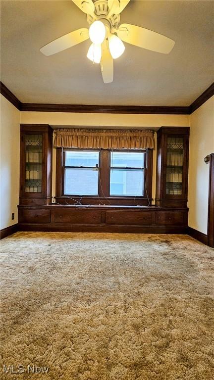 10612 Linnet Ave, Cleveland, OH 44111 - empty room featuring crown molding, baseboards, healthy amount of natural light, and ceiling fan