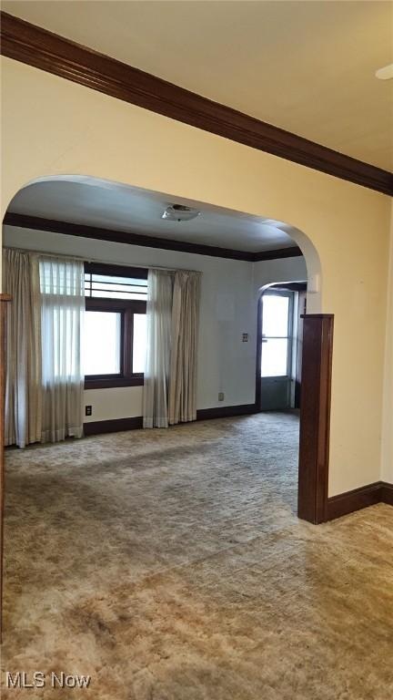 10612 Linnet Ave, Cleveland, OH 44111 - unfurnished room with arched walkways, crown molding, baseboards, and carpet