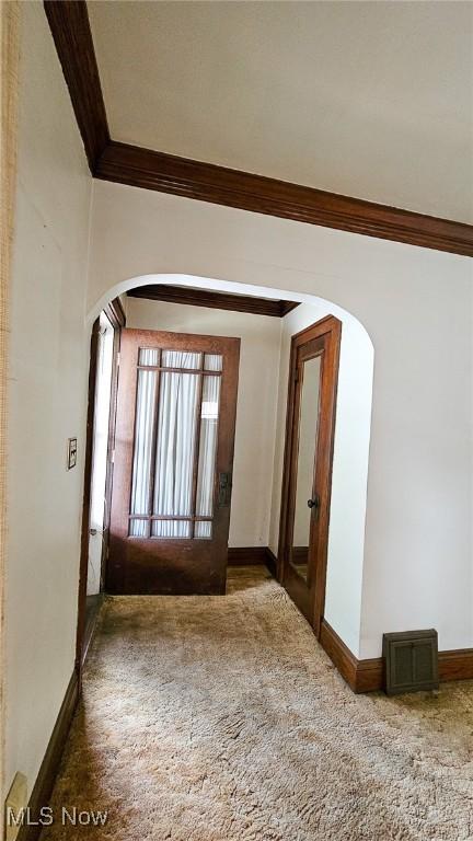 10612 Linnet Ave, Cleveland, OH 44111 - carpeted empty room with arched walkways, crown molding, and baseboards