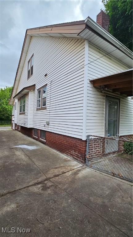 10612 Linnet Ave, Cleveland, OH 44111 - view of side of property featuring a chimney