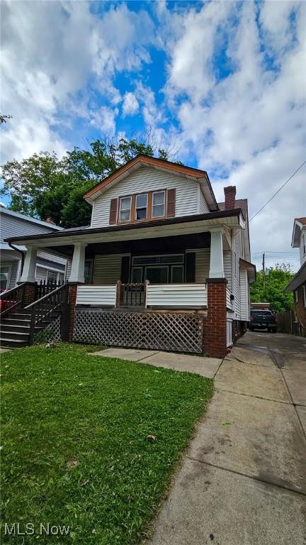 10612 Linnet Ave, Cleveland, OH 44111 - bungalow-style home featuring covered porch, a front lawn, driveway, and a chimney
