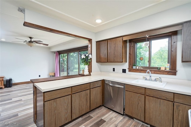 200 Granger Rd, Medina, OH 44256 - kitchen with stainless steel dishwasher, a sink, a peninsula, and light countertops