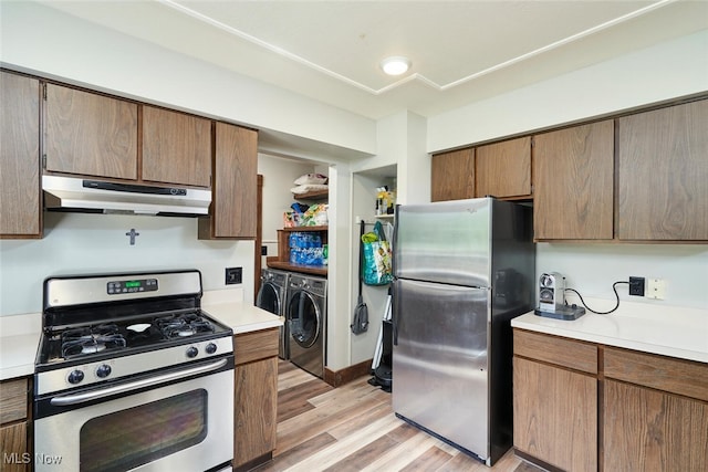 200 Granger Rd, Medina, OH 44256 - kitchen featuring stainless steel appliances, under cabinet range hood, separate washer and dryer, light wood-type flooring, and light countertops